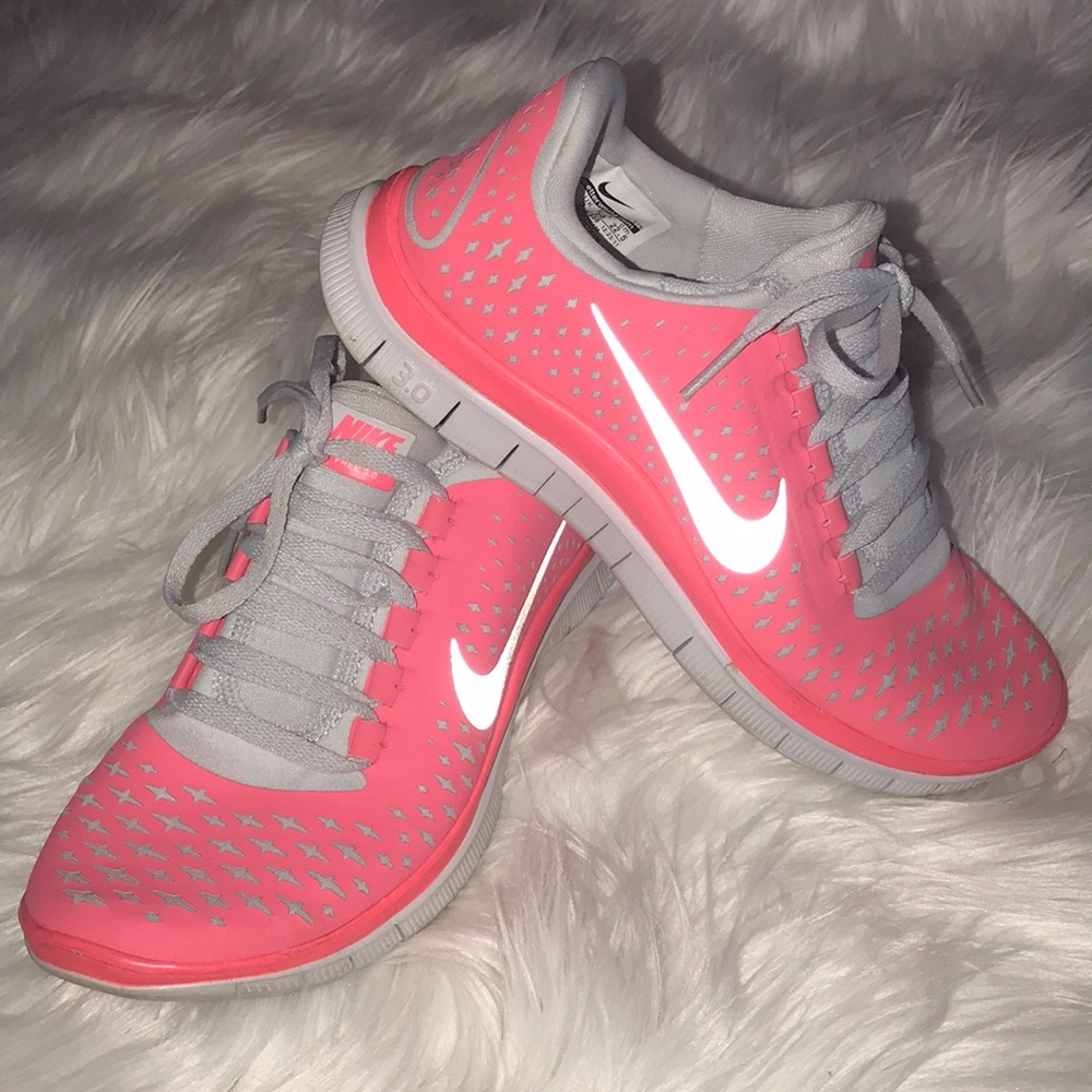 Neon coral Nike Free 3.0 athletic shoes